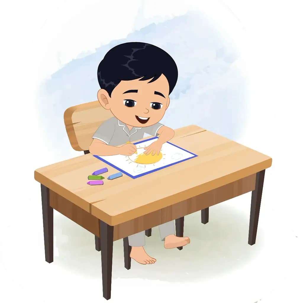 An Indian boy is sitting at a table with some crayons and colouring on the paper aka ishaan